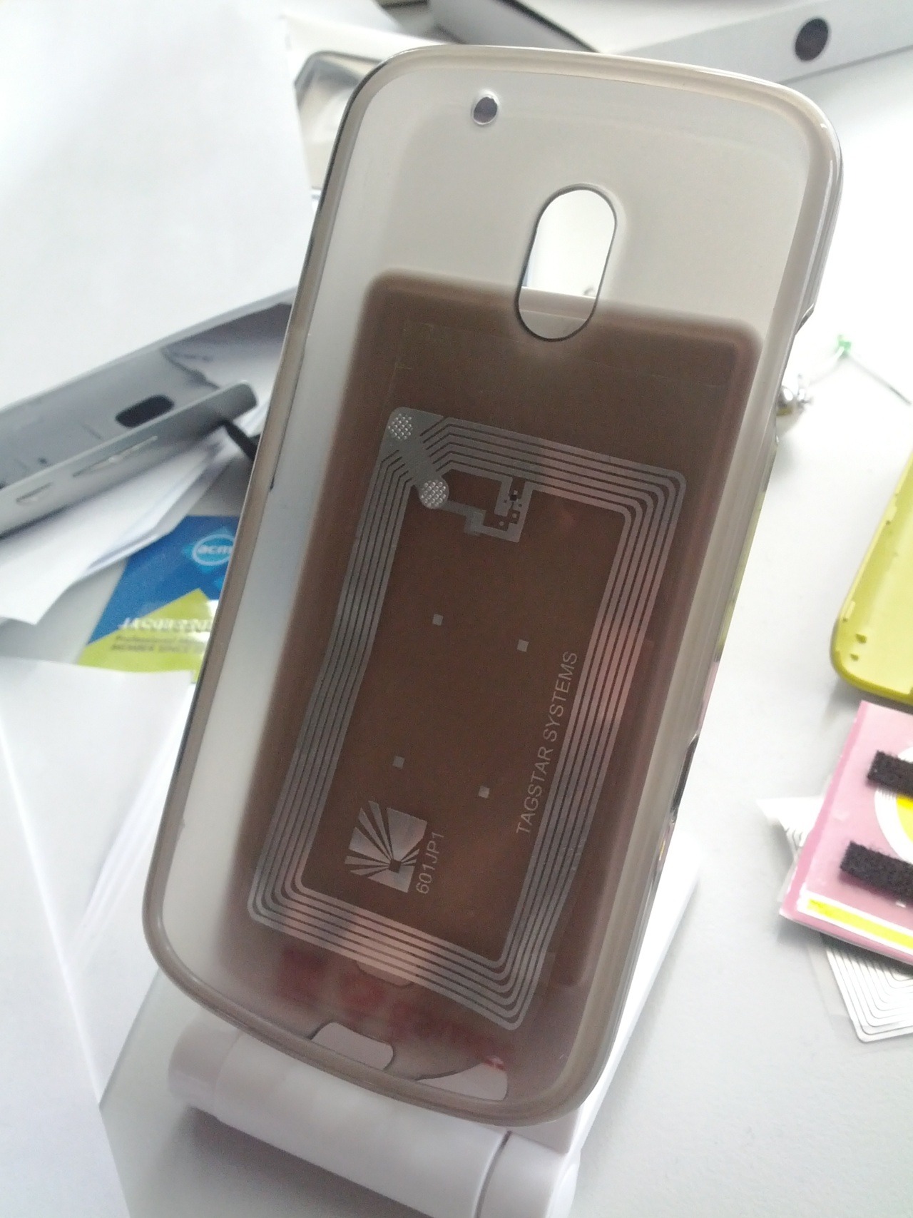 Phone in a translucent case with a visible NFC tag inside